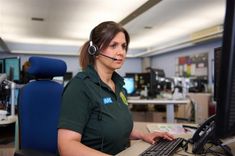 Call handler at computer desk taking a call