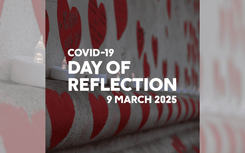 Wall painted with hearts with a row of candles along. Text reads: COVID-19 Day of Reflection 9 March 2025