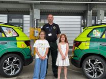Driver trainer James Manship with art competition winner Olivia Hart and Amelia Hutchings