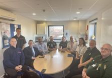 Duncan Baker MP and EEAST Chair Mrunal Sisodia OBE sat around a table with EEAST community first responders and colleagues from Norfolk Fire and Rescue Service at Sheringham Fire Station.