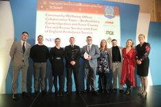 Community Wellbeing Officers from Bedfordshire, Cambridgeshire and Essex fire and rescue services accepting an award