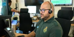 EEAST member of staff wearing a headset and working on a computer