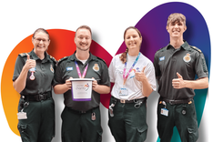 Group of EEAST volunteers holding a charity fundraising bucket, with their thumbs up smiling.