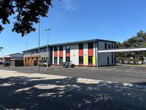 An new, state-of-the-art ambulance hub in Ipswich with two vehicles in front of the building