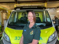 EEAST staff member standing in front of a stationery ambulance