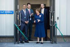 The Lord-Lieutenant of Suffolk, Clare, Countess of Euston, cuts the ribbon to officially open the Ipswich Ambulance Hub, joined by Mrunal Sisodia OBE, Jack Abbott MP and Neill Moloney, all dressed in suits