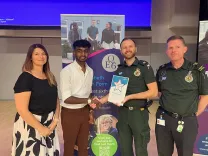 a student receiving an award with fellow EEAST staff