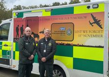 Simon Chase and Terry Hicks standing in front of a specially liveried Remembrance Ambulance