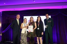 EEAST CEO Neill Moloney (left) and Chief Operating Officer Darren Meads (right) present the Excellence in Supporting Patient Care Award to the East of England Ambulance Service Charity team. 