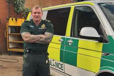Stephen Hughes in ambulance uniform beside an ambulance officer vehicle