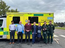 Photo of EEAST staff next to a stationery ambulance