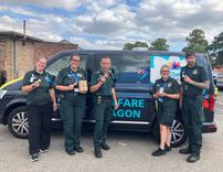 EEAST staff and volunteers standing in front of a welfare wagon
