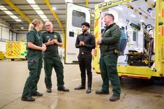 EEAST staff standing next to a stationery ambulance