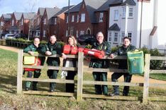 Community First Responders stood behind a fence